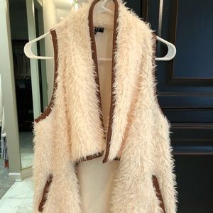 Faux fur vest trimmed w/ light brown faux leather.